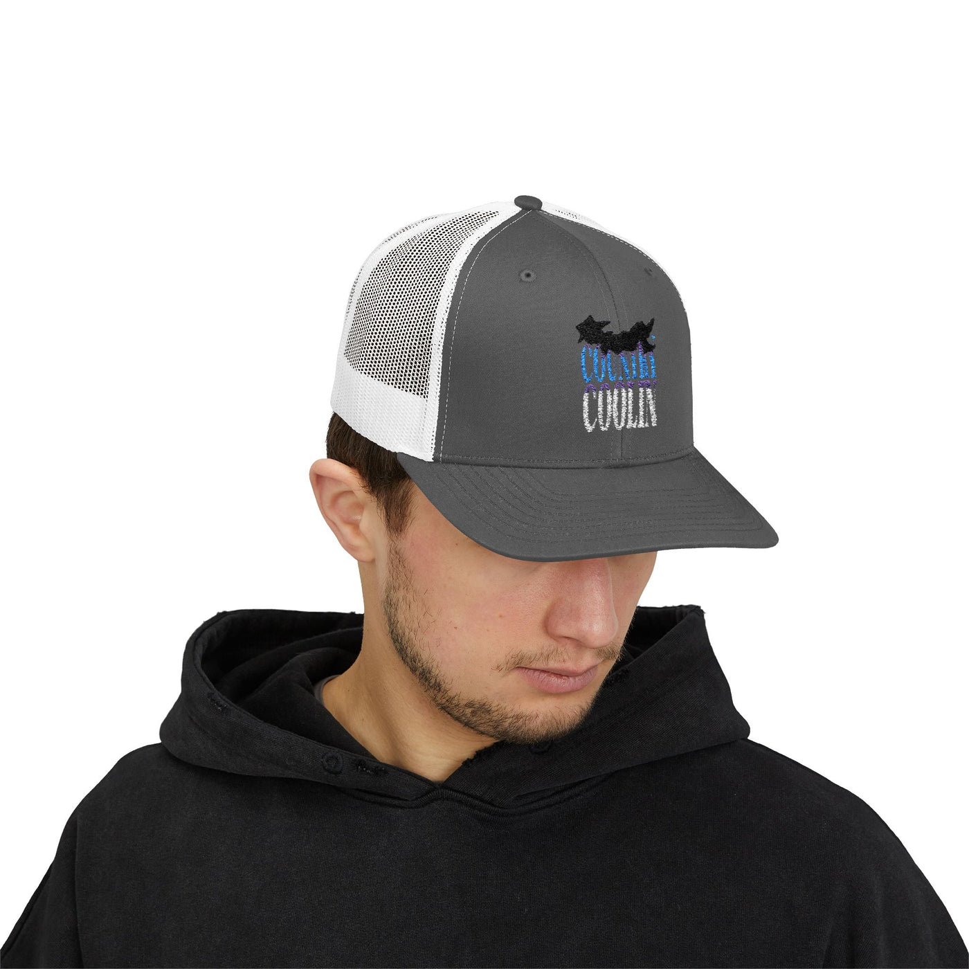 Trucker snapback cap in gray and white, featuring 'Cool Vibe' design, worn by a young man in a black hoodie.